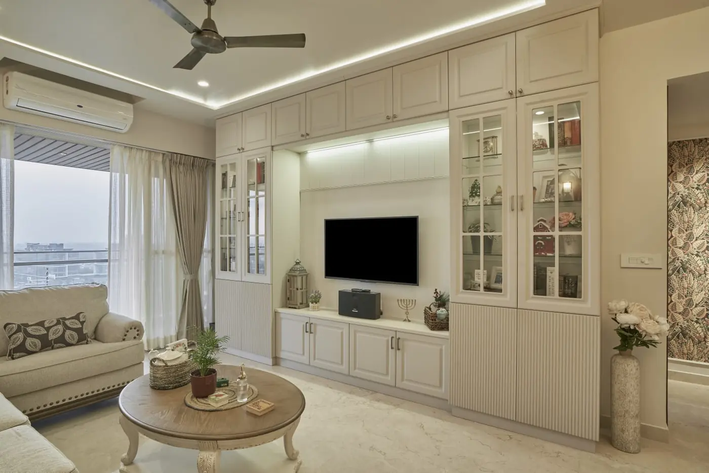 Modular TV unit with glass display cabinets and profile lighting, Pune